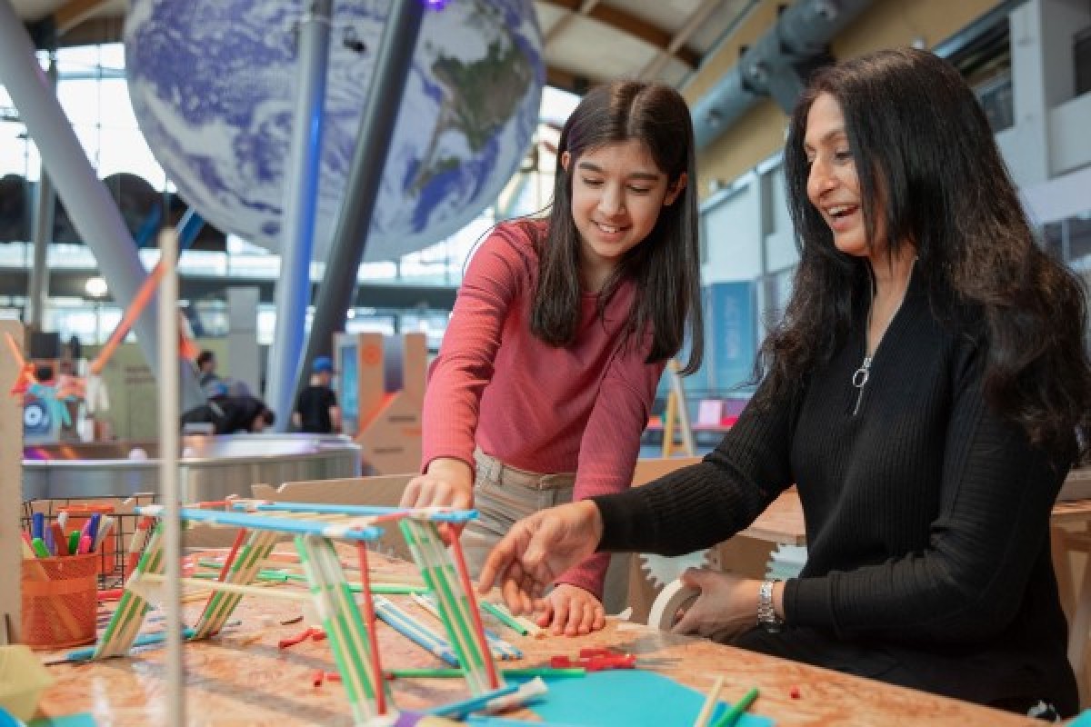 A mother and daughter building a bridge out of crafts at Life Science Centre